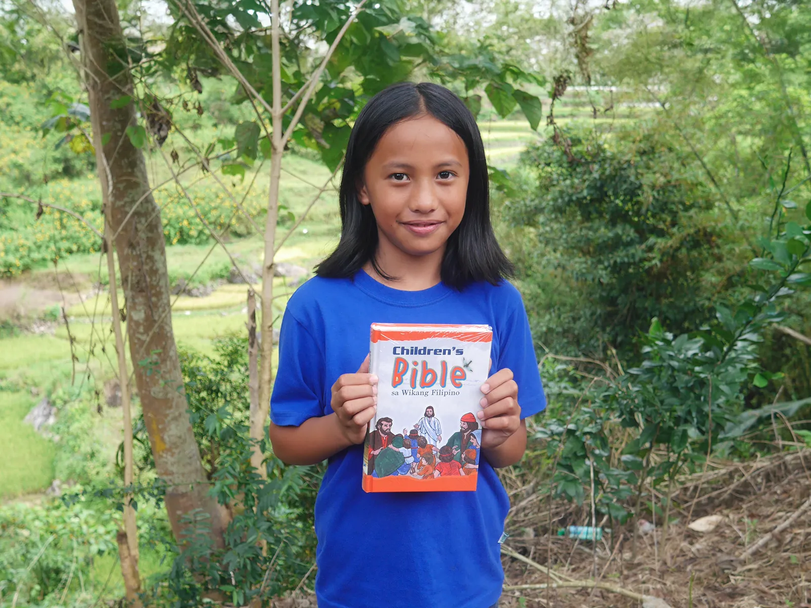 About Bible League Girl Holding Childrens Bible
